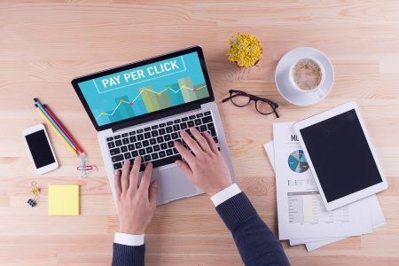 Businessman is working on laptop with - PAY PER CLICK on the screen