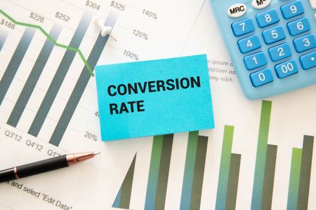 Text conversion rate on a white notebook sheet.