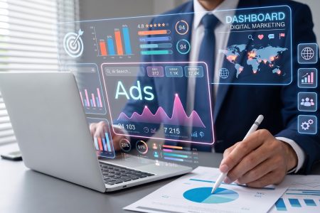 man working at laptop with graphic of digital marketing dashboard